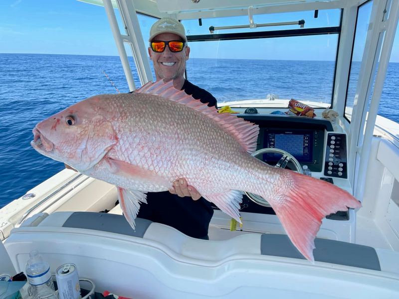 Angler with a big red snapper on a Sarasota offshore charter