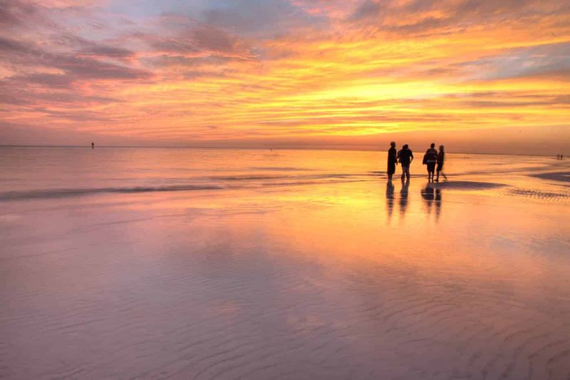 People hanging out on the beach at last light.