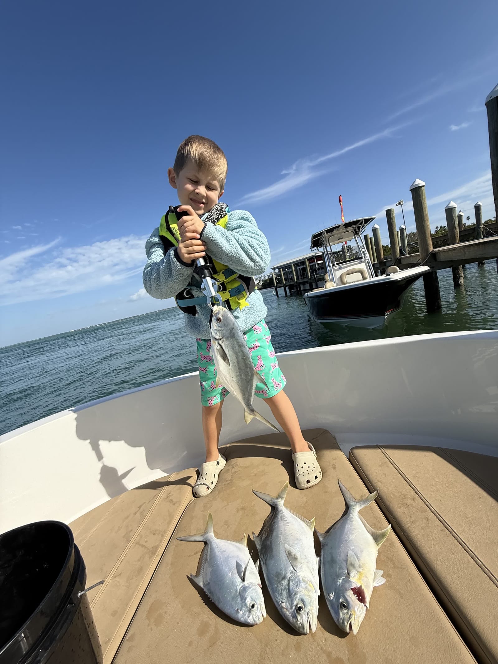 A young angler with a haul of pompano — this is what a great trip looks like.