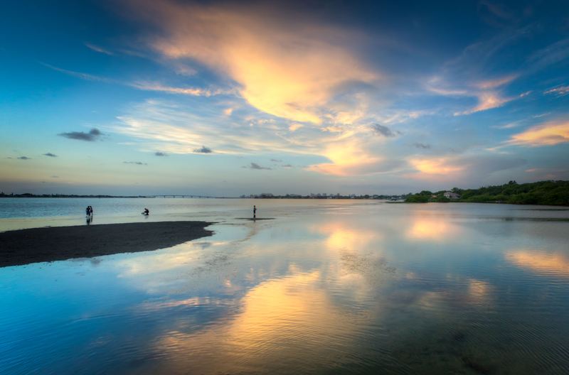A secluded sandbar at low tide.