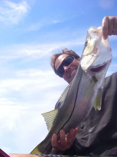 Angler holding a snook up toward the camera