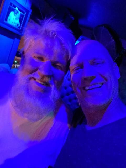 Capt. Steve and fisherman John Daly, side by side under blue light