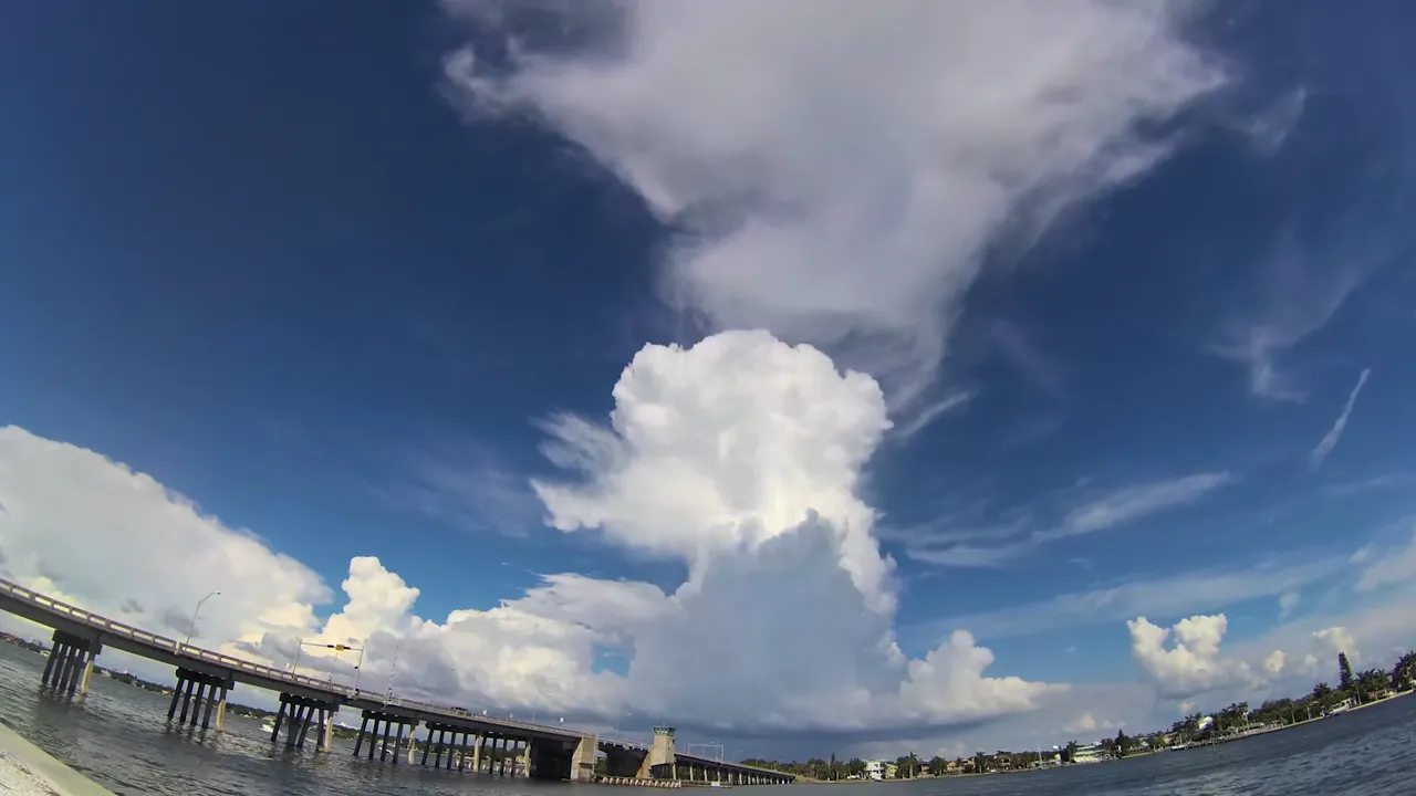 Thunderheads stack up inshore while the beach bite is still on.