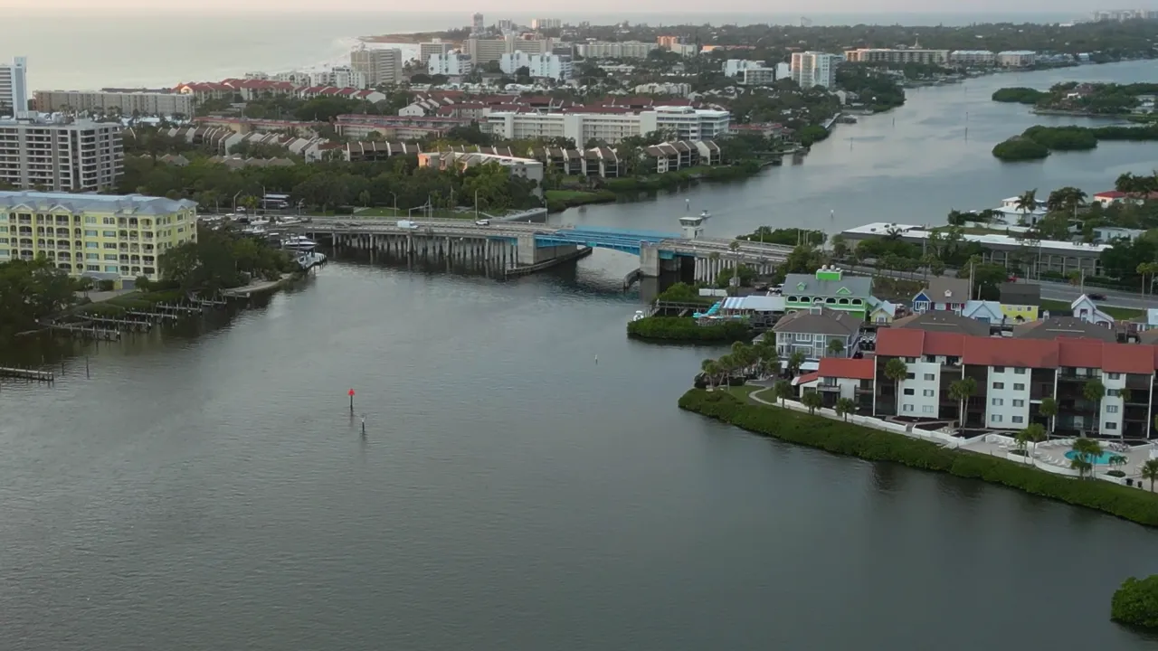 Stickney Point and the north bridge light up after dark — snook hold the shadow line.